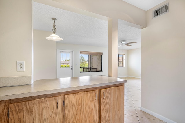 521 Shady Pine Way Unit C2, Greenacres, FL 33415 - kitchen featuring light tile patterned flooring, ceiling fan, decorative light fixtures, light countertops, and a peninsula