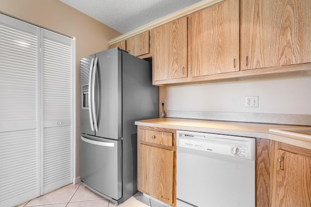 521 Shady Pine Way Unit C2, Greenacres, FL 33415 - kitchen with white dishwasher, stainless steel fridge, light countertops, a textured ceiling, and light tile patterned floors