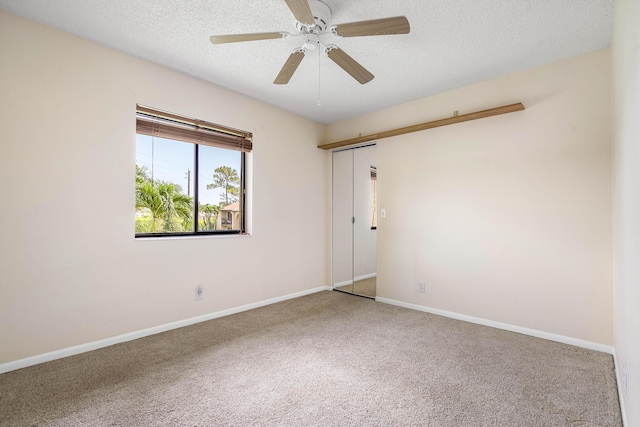 521 Shady Pine Way Unit C2, Greenacres, FL 33415 - empty room with carpet, a ceiling fan, a textured ceiling, and baseboards