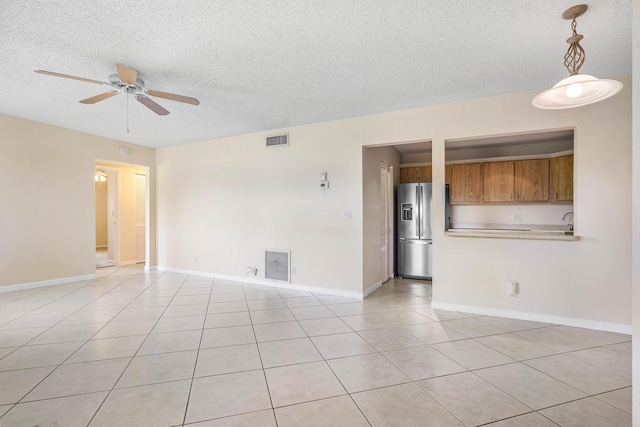 521 Shady Pine Way Unit C2, Greenacres, FL 33415 - spare room with ceiling fan, a textured ceiling, baseboards, and light tile patterned floors