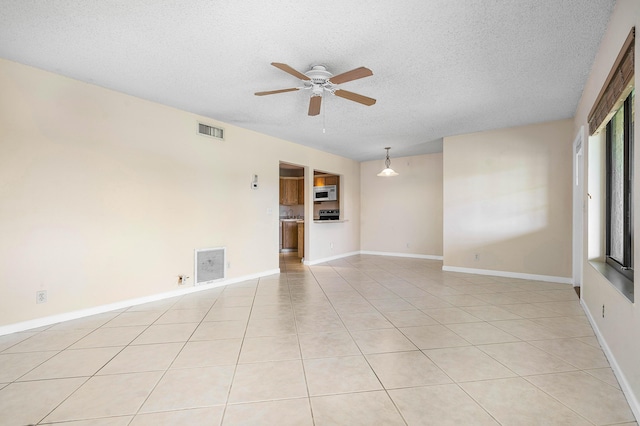 521 Shady Pine Way Unit C2, Greenacres, FL 33415 - spare room with a textured ceiling, a ceiling fan, light tile patterned floors, and baseboards