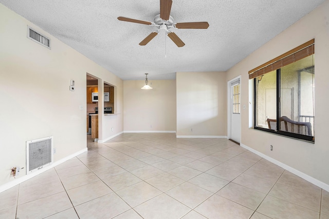 521 Shady Pine Way Unit C2, Greenacres, FL 33415 - empty room featuring a textured ceiling, light tile patterned floors, a ceiling fan, and baseboards