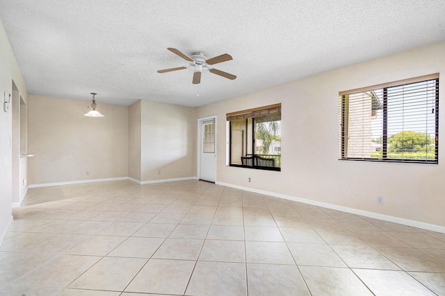521 Shady Pine Way Unit C2, Greenacres, FL 33415 - unfurnished room featuring a textured ceiling, a ceiling fan, light tile patterned floors, and baseboards