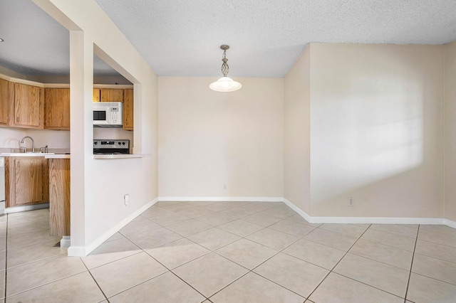521 Shady Pine Way Unit C2, Greenacres, FL 33415 - unfurnished dining area with light tile patterned floors, a textured ceiling, a sink, and baseboards