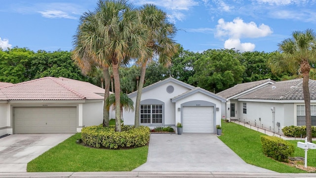 8085 Tortuga Ln, Boynton Beach, FL 33436 - single story home featuring concrete driveway, stucco siding, a front yard, and an attached garage