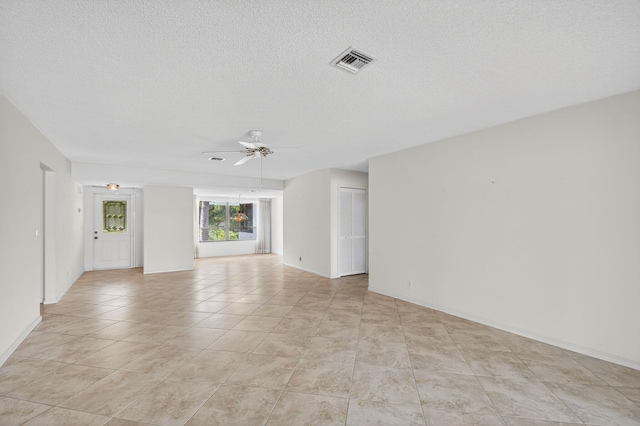 3946 Quail Ridge Dr N, Boynton Beach, FL 33436 - unfurnished living room featuring a ceiling fan, light tile patterned floors, and a textured ceiling