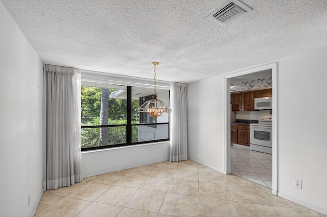 3946 Quail Ridge Dr N, Boynton Beach, FL 33436 - unfurnished dining area with a chandelier, a textured ceiling, and light tile patterned flooring
