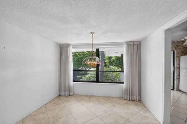 3946 Quail Ridge Dr N, Boynton Beach, FL 33436 - tiled spare room with a textured ceiling, a chandelier, and baseboards