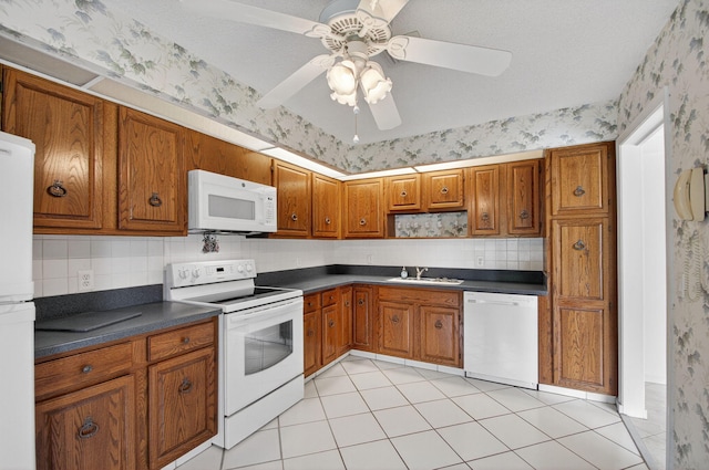 3946 Quail Ridge Dr N, Boynton Beach, FL 33436 - kitchen with white appliances, wallpapered walls, dark countertops, brown cabinets, and open shelves