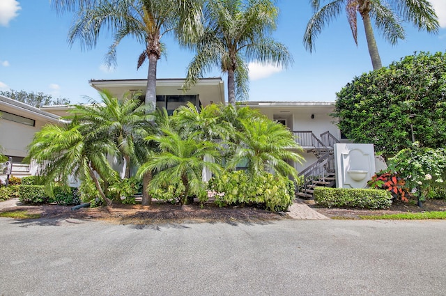 3946 Quail Ridge Dr N, Boynton Beach, FL 33436 - obstructed view of property featuring stairs and stucco siding