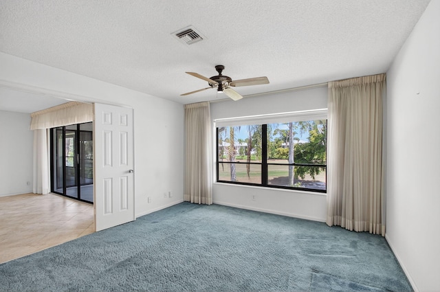 3946 Quail Ridge Dr N, Boynton Beach, FL 33436 - spare room with healthy amount of natural light, carpet flooring, a ceiling fan, and a textured ceiling