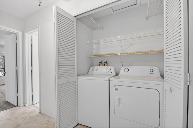 3946 Quail Ridge Dr N, Boynton Beach, FL 33436 - laundry room featuring washer and dryer and light tile patterned floors