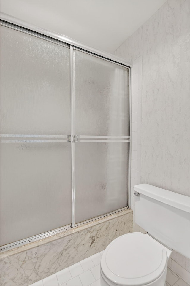 3946 Quail Ridge Dr N, Boynton Beach, FL 33436 - bathroom with toilet, bath / shower combo with glass door, and tile patterned floors