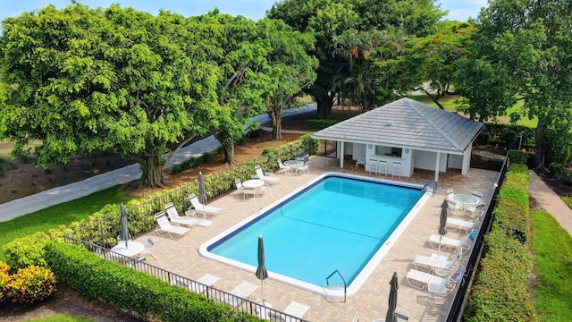 3946 Quail Ridge Dr N, Boynton Beach, FL 33436 - community pool featuring a patio and an outdoor structure