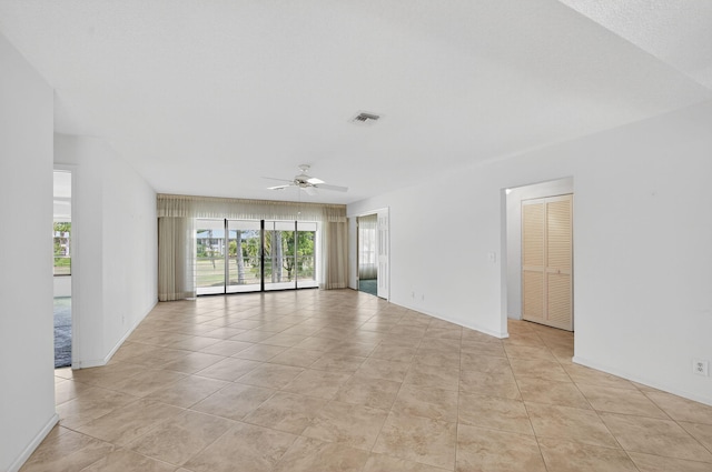 3946 Quail Ridge Dr N, Boynton Beach, FL 33436 - spare room featuring a ceiling fan, light tile patterned floors, and baseboards
