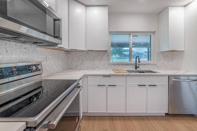 18085 102nd Way S, Boca Raton, FL 33498 - kitchen with stainless steel appliances, white cabinetry, light stone counters, and backsplash