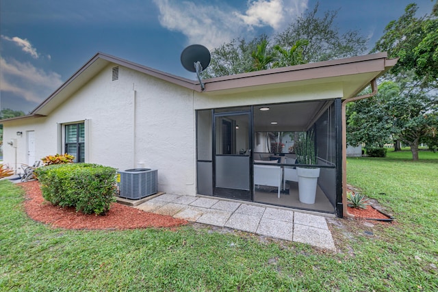 18085 102nd Way S, Boca Raton, FL 33498 - rear view of house with a sunroom, stucco siding, and a yard