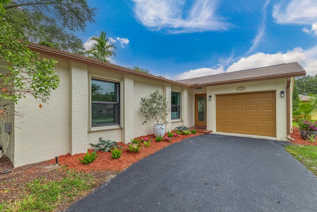 18085 102nd Way S, Boca Raton, FL 33498 - view of front facade with stucco siding, asphalt driveway, and an attached garage