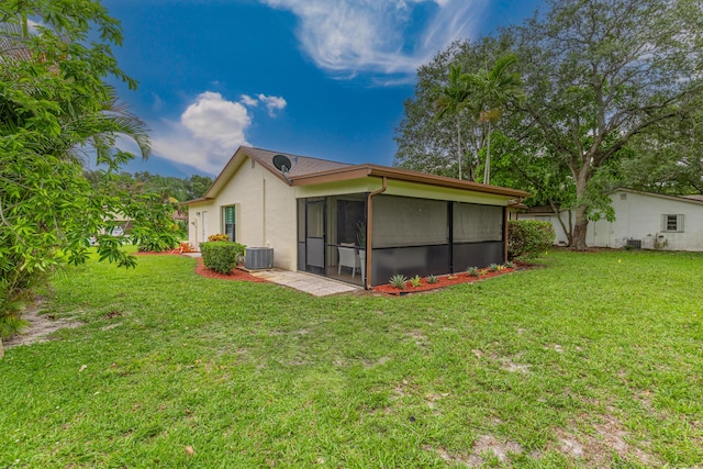 18085 102nd Way S, Boca Raton, FL 33498 - back of house featuring a sunroom, stucco siding, and a yard