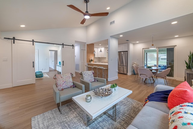 18085 102nd Way S, Boca Raton, FL 33498 - living room with a barn door, ceiling fan, light wood finished floors, recessed lighting, and high vaulted ceiling