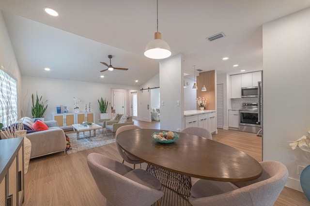 18085 102nd Way S, Boca Raton, FL 33498 - dining space featuring a barn door, light wood-style flooring, a ceiling fan, recessed lighting, and lofted ceiling