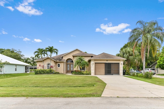 2450 SW Summit St, Port Saint Lucie, FL 34984 - view of front of home featuring a garage, stucco siding, driveway, and a front yard