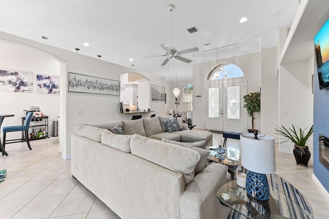 2450 SW Summit St, Port Saint Lucie, FL 34984 - living area featuring light tile patterned floors, a ceiling fan, recessed lighting, arched walkways, and baseboards