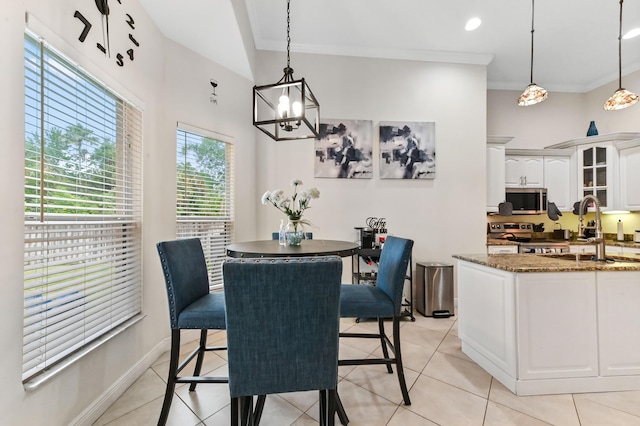2450 SW Summit St, Port Saint Lucie, FL 34984 - dining room with light tile patterned floors, a chandelier, baseboards, and crown molding