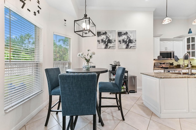 2450 SW Summit St, Port Saint Lucie, FL 34984 - dining room featuring a chandelier, crown molding, light tile patterned floors, and baseboards