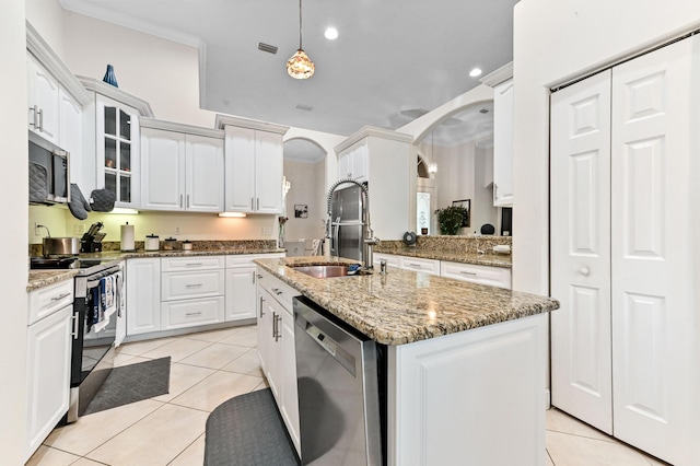 2450 SW Summit St, Port Saint Lucie, FL 34984 - kitchen featuring appliances with stainless steel finishes, a sink, arched walkways, light tile patterned floors, and recessed lighting