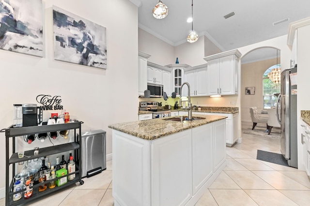 2450 SW Summit St, Port Saint Lucie, FL 34984 - kitchen with a sink, appliances with stainless steel finishes, crown molding, arched walkways, and light tile patterned floors