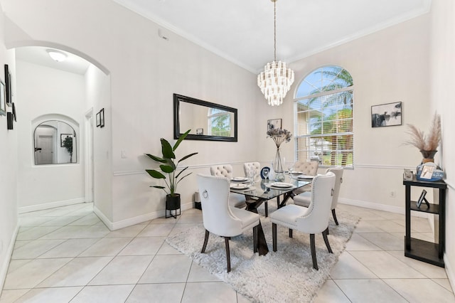 2450 SW Summit St, Port Saint Lucie, FL 34984 - dining room featuring arched walkways, light tile patterned floors, ornamental molding, baseboards, and a chandelier