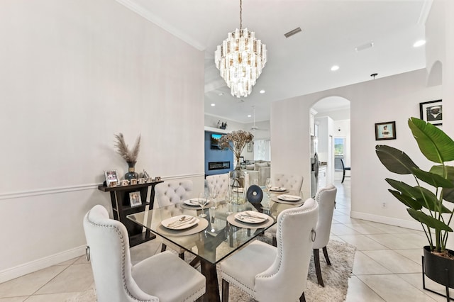 2450 SW Summit St, Port Saint Lucie, FL 34984 - dining area with arched walkways, light tile patterned floors, a chandelier, baseboards, and recessed lighting