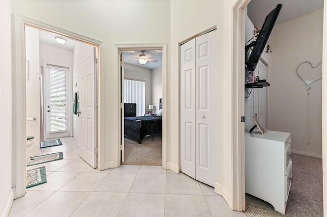 2450 SW Summit St, Port Saint Lucie, FL 34984 - corridor featuring light tile patterned floors, baseboards, and light colored carpet