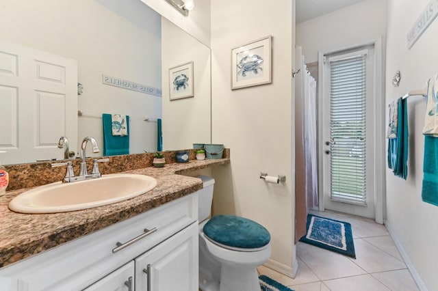2450 SW Summit St, Port Saint Lucie, FL 34984 - bathroom with baseboards, tile patterned flooring, vanity, and toilet