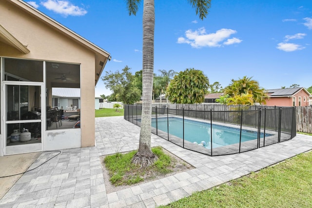 2450 SW Summit St, Port Saint Lucie, FL 34984 - view of pool featuring a fenced backyard, a patio area, and a sunroom