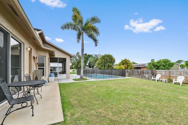 2450 SW Summit St, Port Saint Lucie, FL 34984 - view of yard with a sunroom and a patio