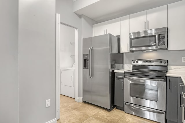 4903 Midtown Ln Unit 3114, Palm Beach Gardens, FL 33418 - kitchen featuring appliances with stainless steel finishes, light countertops, light tile patterned floors, and white cabinets