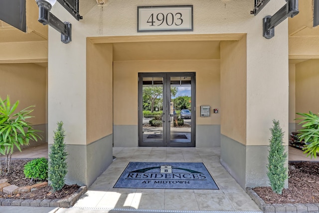 4903 Midtown Ln Unit 3114, Palm Beach Gardens, FL 33418 - doorway to property featuring french doors and stucco siding