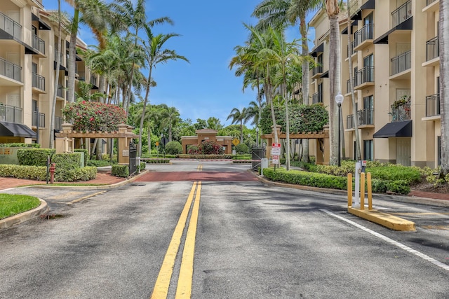 4903 Midtown Ln Unit 3114, Palm Beach Gardens, FL 33418 - view of asphalt road featuring curbs and street lighting