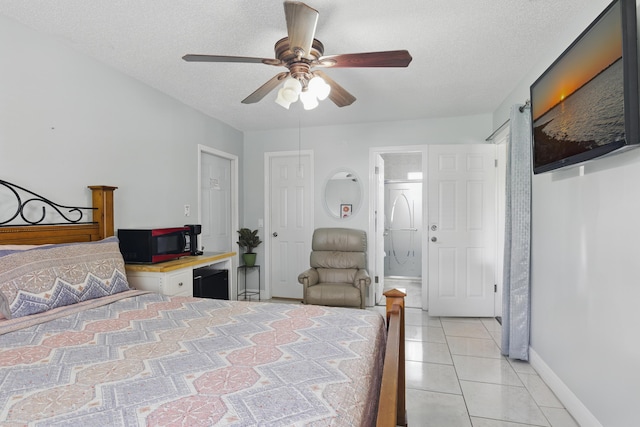 1913 SW Idaho Ln, Port Saint Lucie, FL 34953 - bedroom featuring baseboards, light tile patterned floors, a textured ceiling, ceiling fan, and an office area