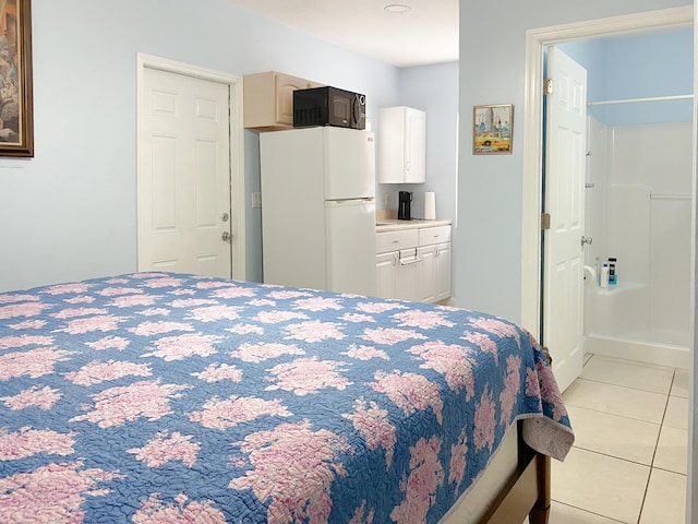 1913 SW Idaho Ln, Port Saint Lucie, FL 34953 - bedroom with freestanding refrigerator and light tile patterned floors