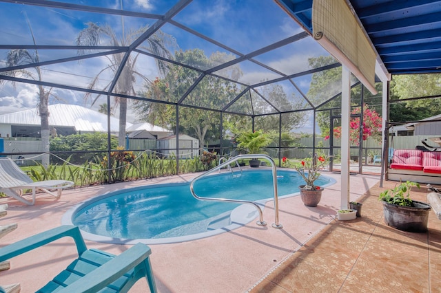 1913 SW Idaho Ln, Port Saint Lucie, FL 34953 - view of swimming pool featuring a patio, a fenced backyard, a lanai, and a storage unit