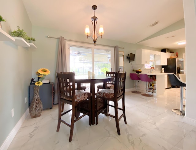 1913 SW Idaho Ln, Port Saint Lucie, FL 34953 - dining area with light marble finish flooring, baseboards, and a chandelier