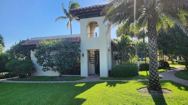 200 S Ocean Blvd Unit B-135, Delray Beach, FL 33483 - view of front of house featuring stucco siding, a tile roof, and a front lawn