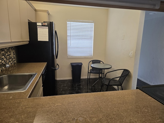 150 Lake Nancy Ln Unit 222, West Palm Beach, FL 33411 - kitchen with a sink, decorative backsplash, baseboards, and dark countertops