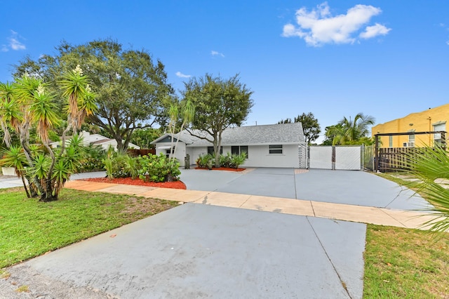 522 Evergreen Dr, Lake Park, FL 33403 - view of front facade featuring a gate, a shingled roof, and driveway
