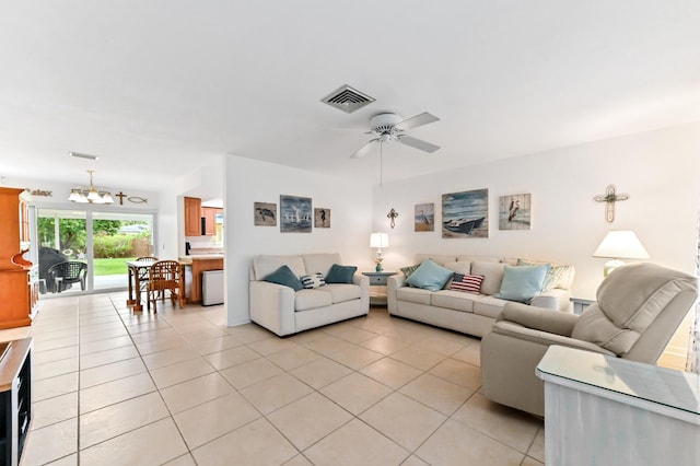522 Evergreen Dr, Lake Park, FL 33403 - living room featuring a chandelier, light tile patterned flooring, and a ceiling fan