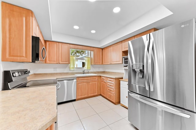 522 Evergreen Dr, Lake Park, FL 33403 - kitchen featuring stainless steel appliances, a sink, light tile patterned floors, light countertops, and recessed lighting