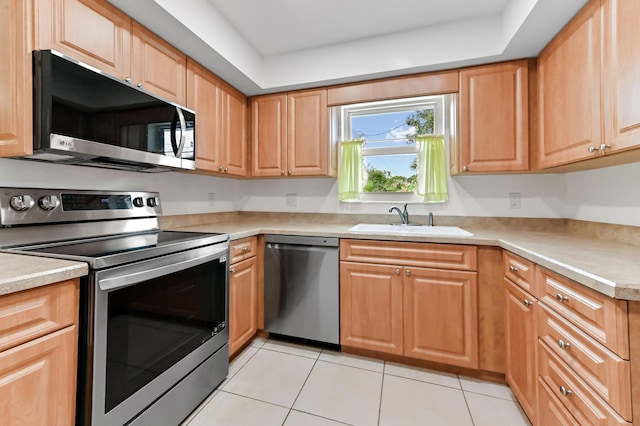 522 Evergreen Dr, Lake Park, FL 33403 - kitchen featuring stainless steel appliances, a sink, light tile patterned floors, and light countertops